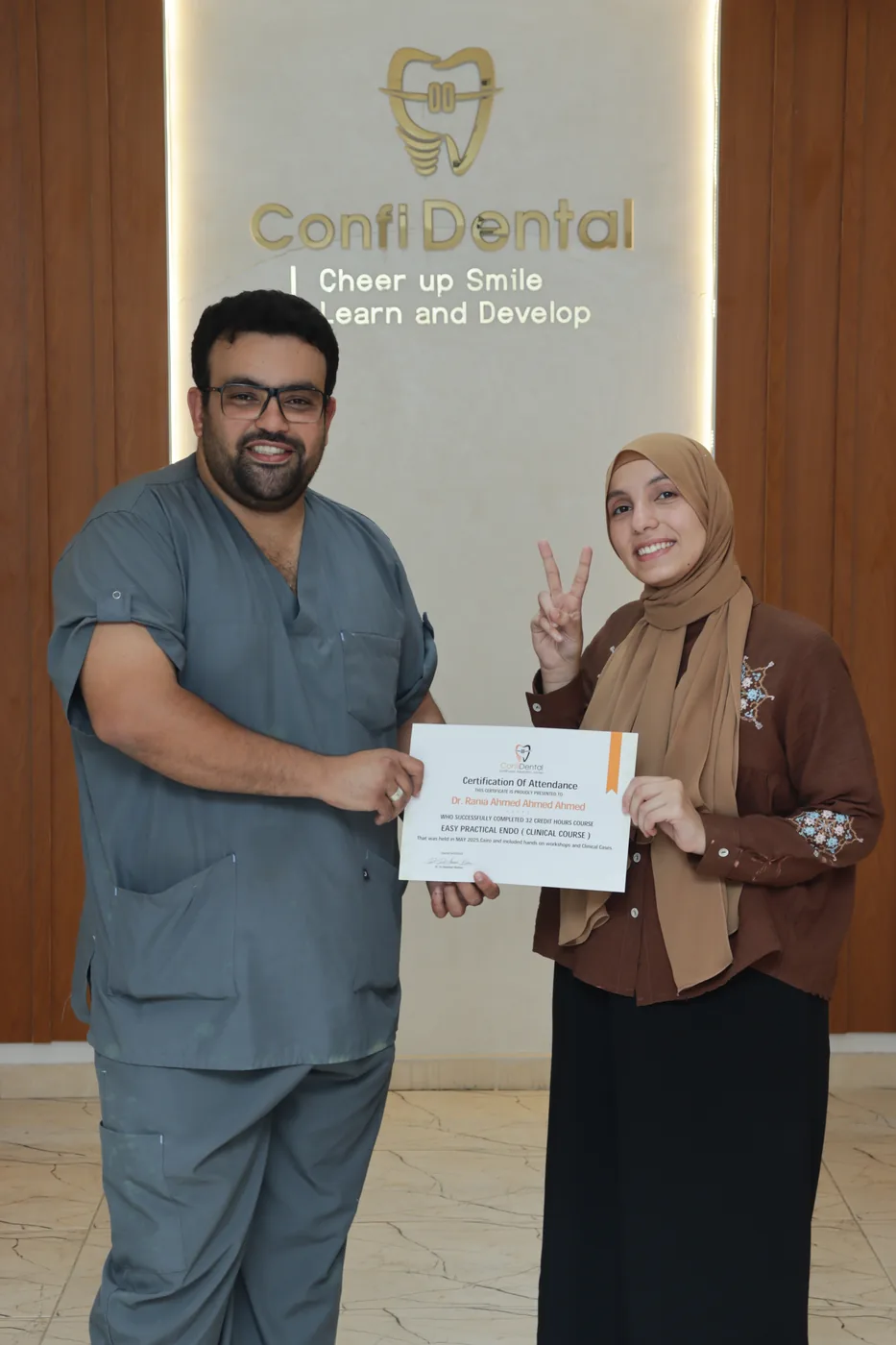 A ConfiDental graduate receiving their certificate of attendance