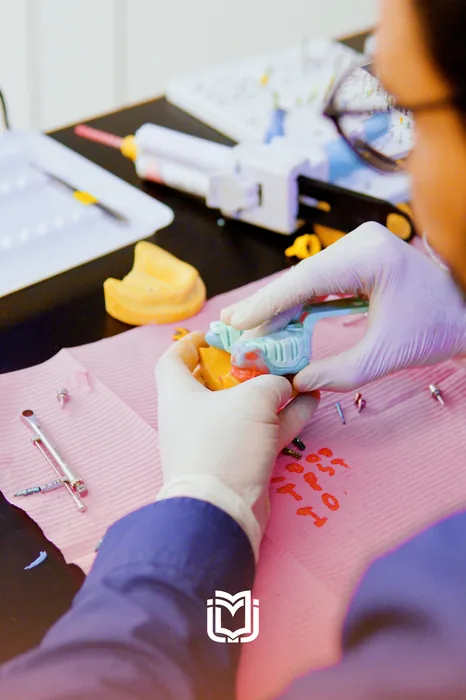 A participant seating an implant model during a hands-on session