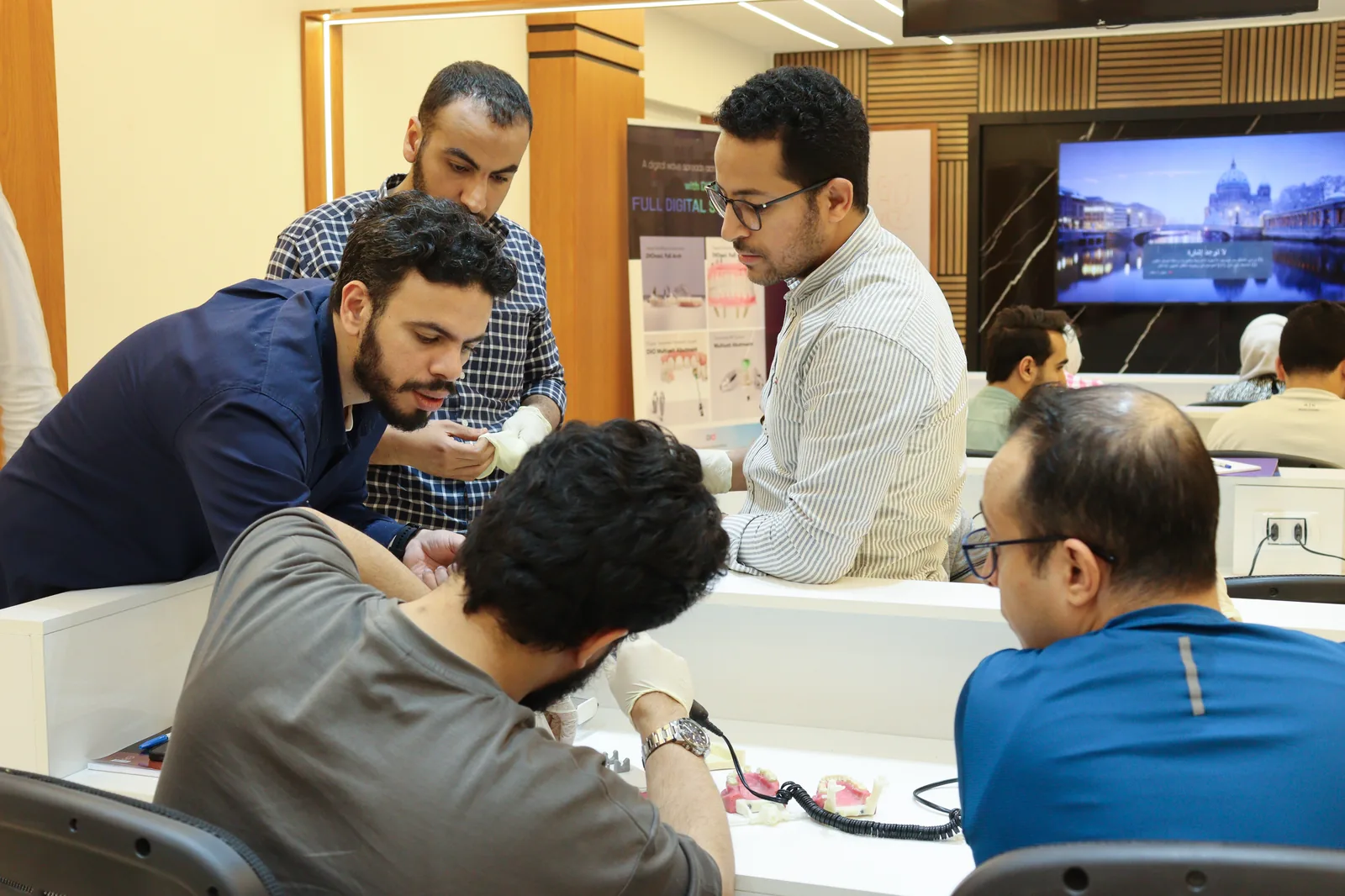 Participants gathered around a workbench during a hands-on session