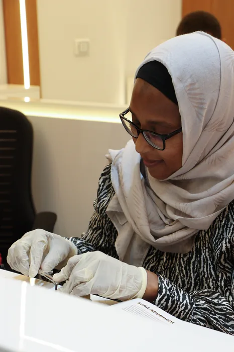 A participant working with a solid abutment at her station