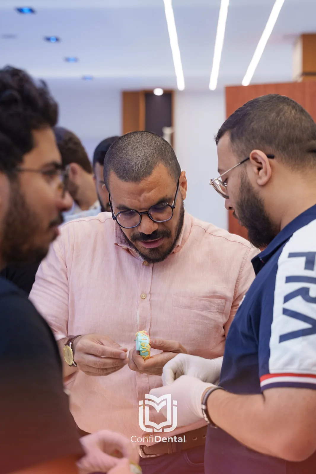 An instructor showing an implant model to participants