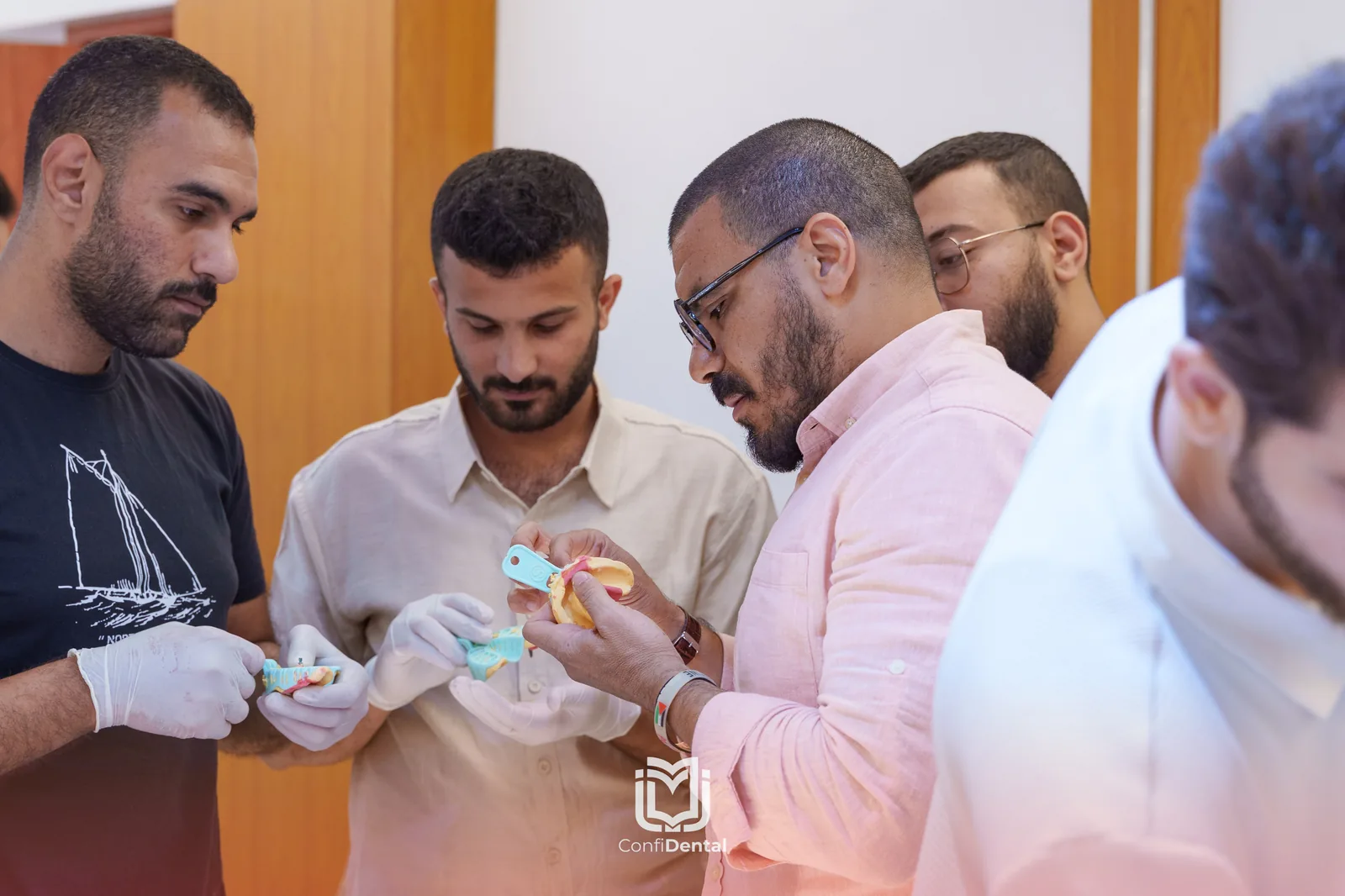 An instructor reviewing implant models with participants
